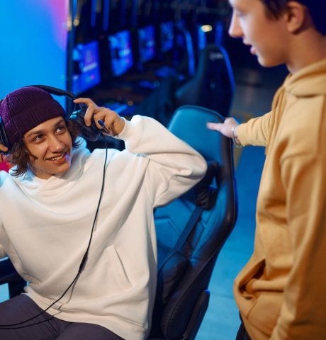 two-gamers-talking-at-the-monitor-in-gaming-club-2021-09-03-06-00-21-utc